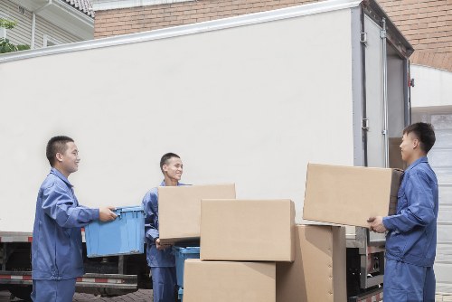 Careful loading of boxes and furniture into a removals van