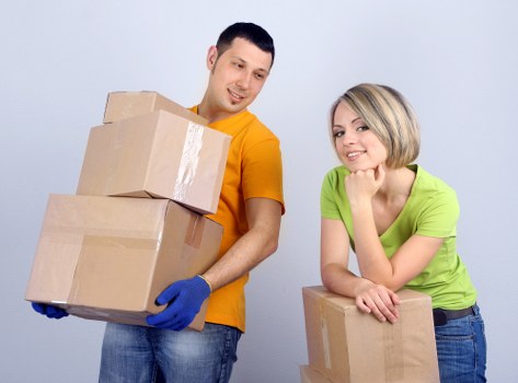 Loading furniture into a moving van near Arkley