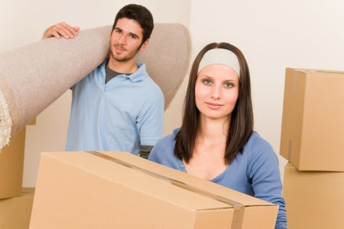 Fragile household items being packed securely by movers